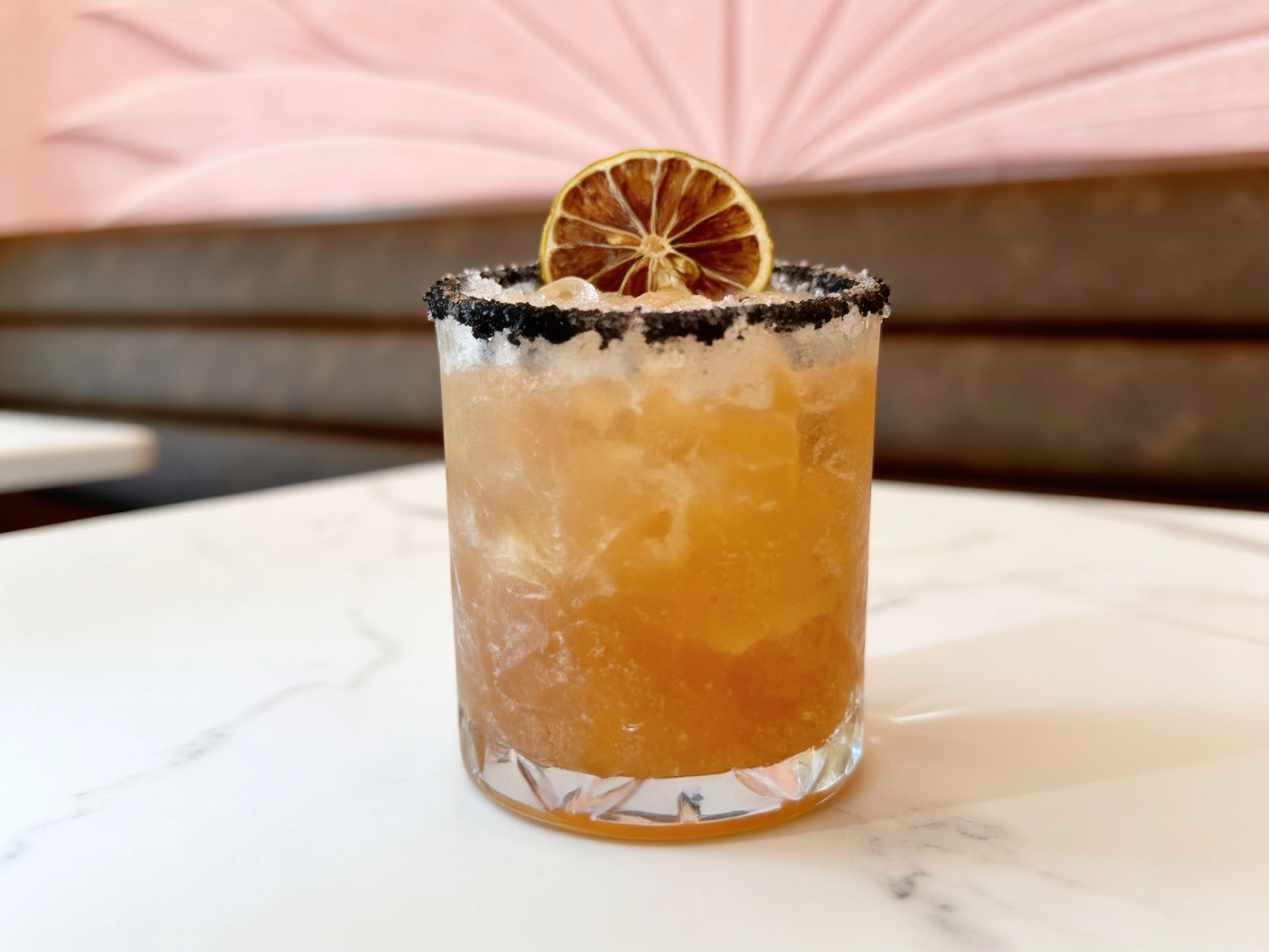 Midnight Margarita, made with allspice, tequila and chocolate bitters, in a rocks glass at the bar